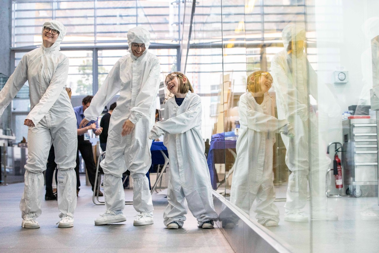 Public engagement and outreach officers Dr Caitriona Tyndall and Alida Zauers with Albi Morrish in the Tyndall Atrium adjoining the cleanroom during Culture Night.