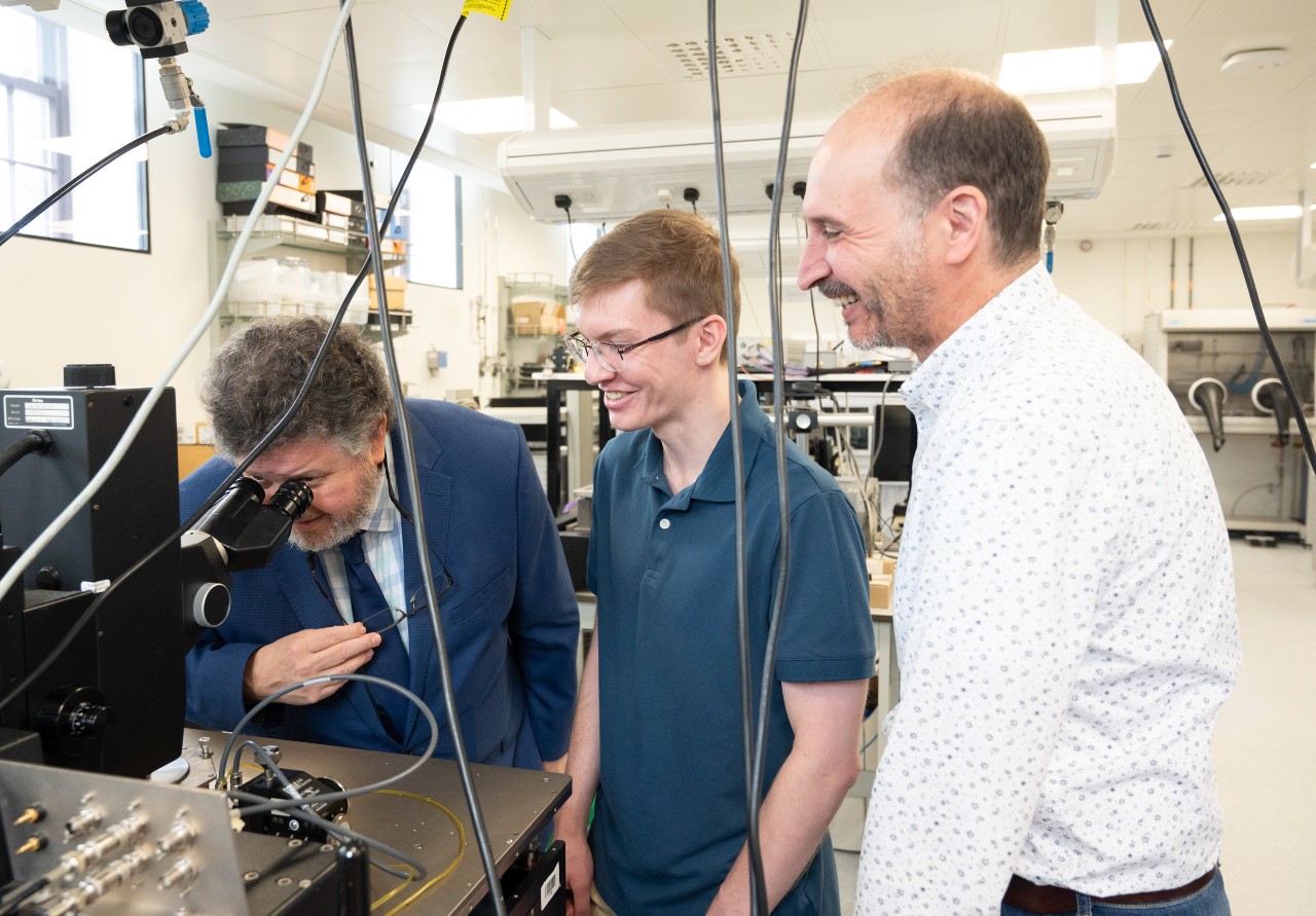 Student Adam Gruszecki and Dr Karim Cherkaoui in the lab with Professor Robert M. Wallace during his visit